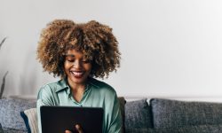 A Happy Beautiful Businesswoman Working From Home On Her Tablet